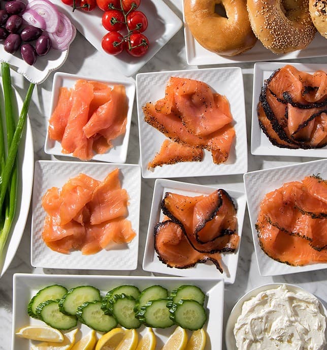An appetizing spread of fresh bagels, smoked salmon, cream cheese, tomatoes, and cucumbers — a classic Zabar's breakfast